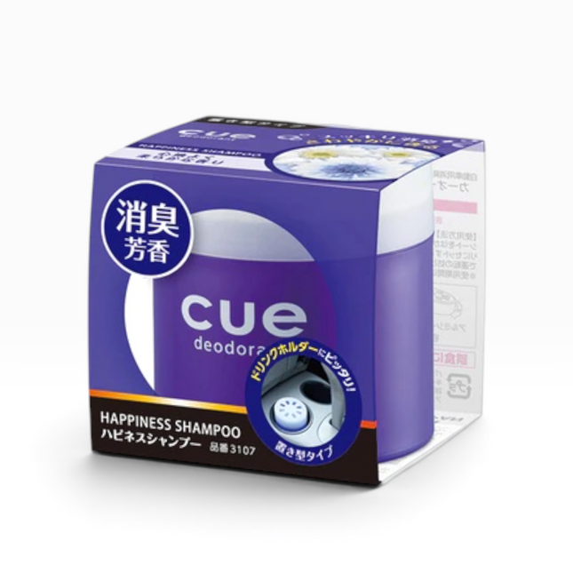 A box of Cue Deodorizer Happiness Shampoo, featuring a purple and white design with Japanese text and a small circular graphic of the dispenser.