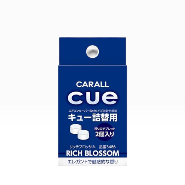 A blue and white box of CARALL cue Lip Balm, specifically the Rich Blossom variant, on a plain white background.