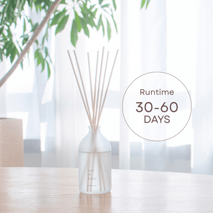 Diffuser with reeds on a table with a blurred background