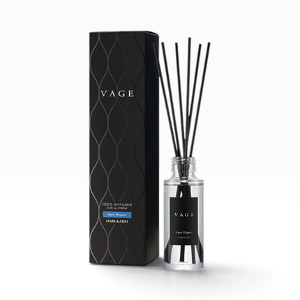 VAGE Hair Kado reed diffuser set featuring a clear glass bottle with black reeds and a black label, standing next to its textured black packaging box on a white background.