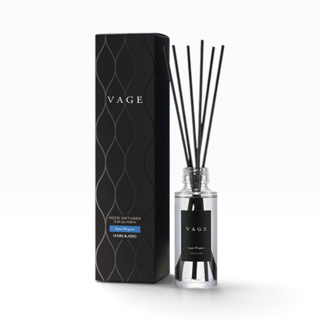 VAGE Hair Kado reed diffuser set featuring a clear glass bottle with black reeds and a black label, standing next to its textured black packaging box on a white background.