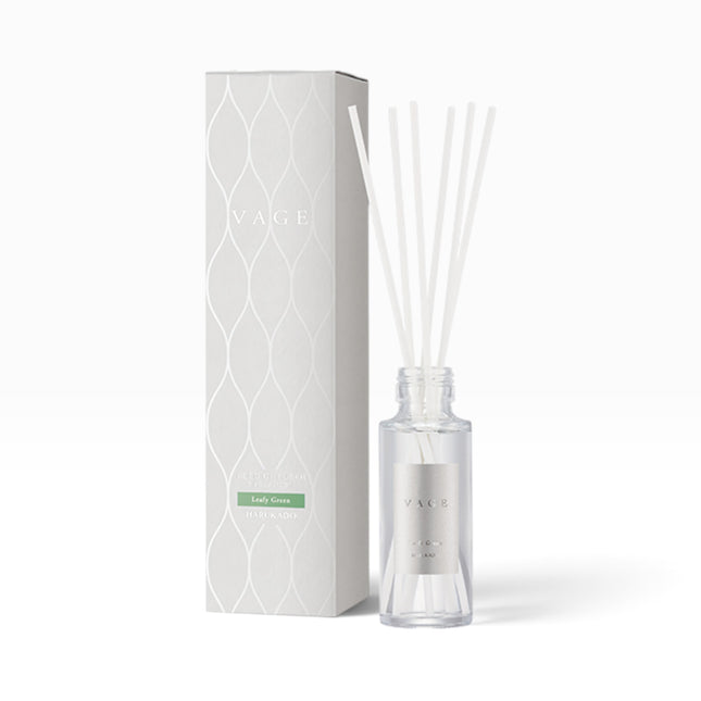 YAGE reed diffuser bottle with clear glass and white reeds next to its white patterned packaging box, labeled Lady Gold.