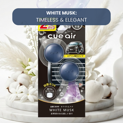 Cue air car air freshener packaging with white musk theme on a decorative background