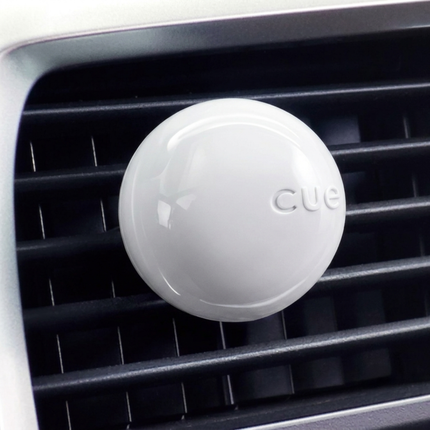 White 'CUE' device on a car's air vent
