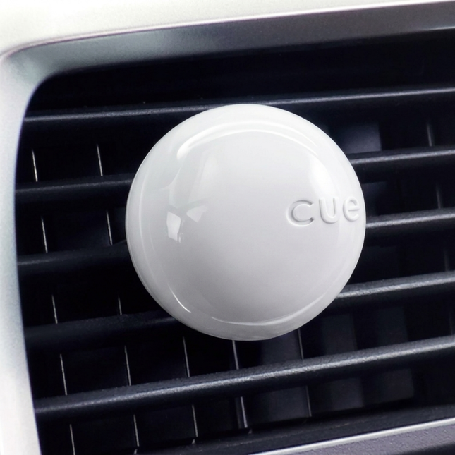 White 'CUE' device on a car's air vent