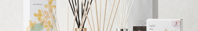 Collection of diffusers and candles on a white background