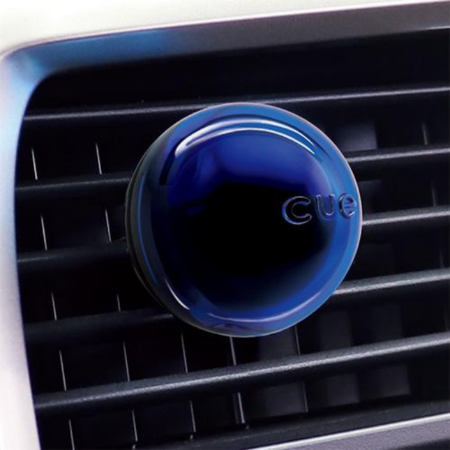 Blue CUE car air freshener on a car's air vent
