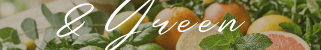 Assorted citrus fruits including lemons, limes, and oranges on a wooden surface with greenery.